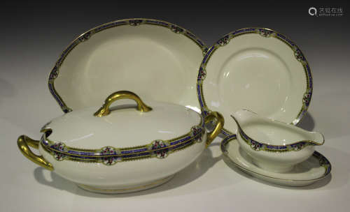 A Limoges part dinner service, 20th century, decorated with a blue ground floral band, including