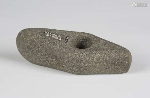 A Danish Neolithic pecked stone axe head of perforated boat form, bearing Hugh Fawcett monogram