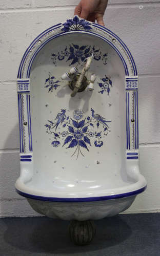 A French Herbeau faience niche water fountain, 20th century, the arched back painted in shades of