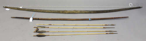 A Papua New Guinea palmwood bow, length 175cm, together with another wooden bow, length 138cm, and