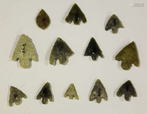 A group of twelve British Bronze Age chipped flint arrowheads of barbed, tanged and leaf design,