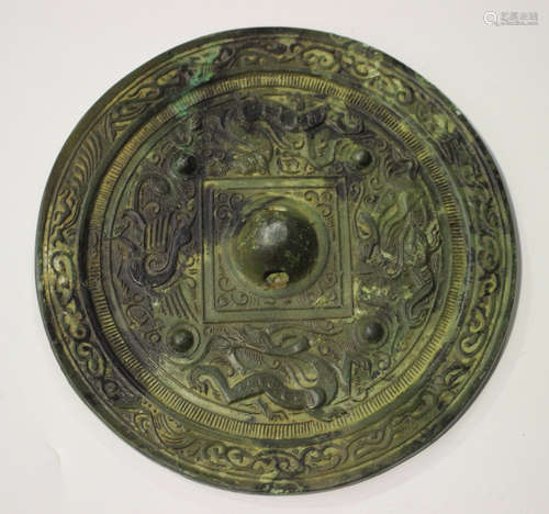 A Chinese archaic bronze circular mirror, possibly Tang dynasty, one side cast with a tiger, a