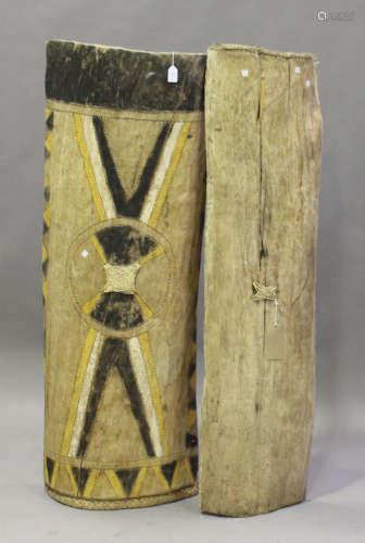Two Papua New Guinea Sepik River carved wooden canoe shields, one with coloured decoration, length