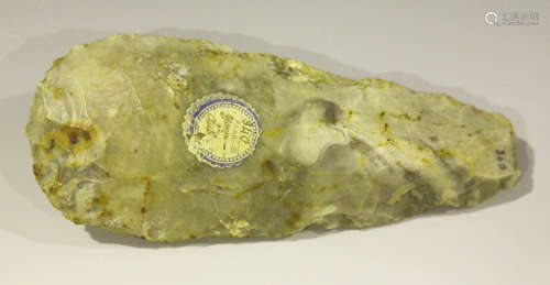 A French Neolithic chipped stone axe head, bearing paper label detailed 'France', length 16.5cm.