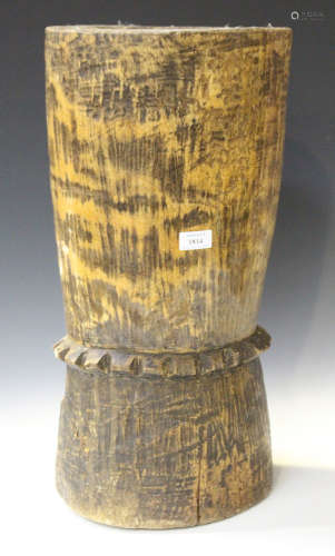 A 20th century African carved wooden pot, height 58cm, together with an African earthenware ovoid