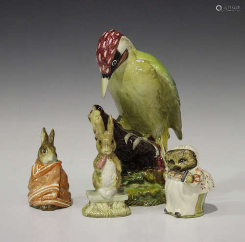 A Beswick woodpecker, No. 1218, height 21cm, together with three Beswick Beatrix Potter figures,