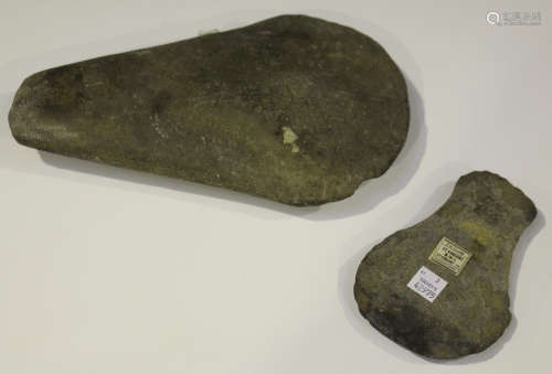 A large pecked stone axe head of expanding form, length 26cm, together with another similar