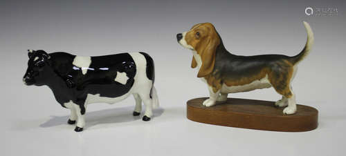 Two Beswick animals, comprising Friesian Bull, No. 1439A, and Bassett Hound, No. 2045B.Buyer’s