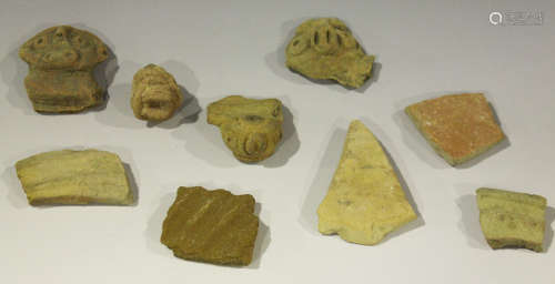A small group of archaeological pottery fragments, including three pre-Columbian masks.Buyer’s