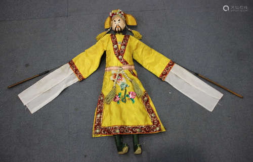 A Chinese puppet of Mr Wu, early 20th century, wearing a yellow silk costume, height 68cm.Buyer’s