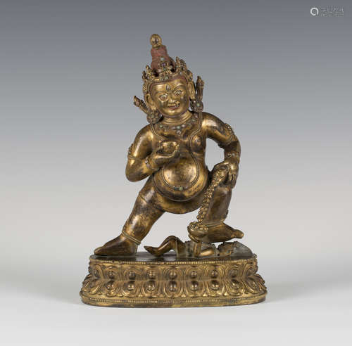 A Sino-Tibetan gilt bronze figure of Jambhala, probably Qing dynasty, the god of wealth modelled