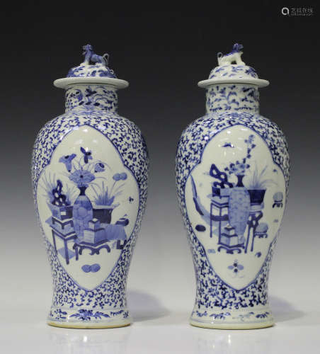 A near pair of Chinese blue and white porcelain vases and covers, mark of Kangxi but late 19th