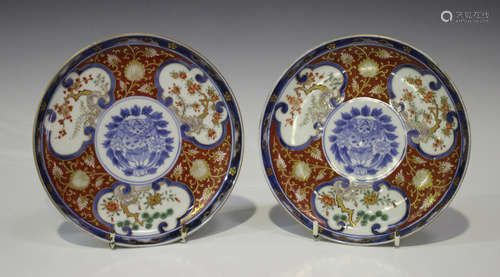 A pair of Japanese Imari porcelain circular side dishes, Meiji period, painted with panels of pine