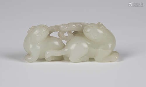 A Chinese pale celadon jade carving, Qing dynasty, probably 18th century, attractively modelled as