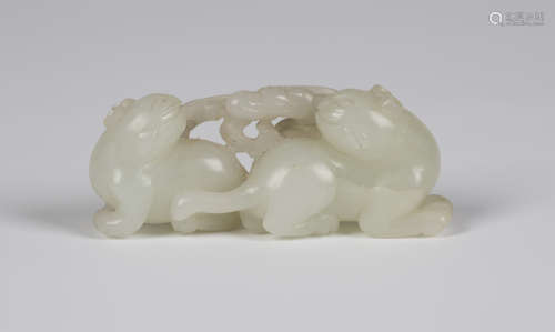 A Chinese pale celadon jade carving, Qing dynasty, probably 18th century, attractively modelled as