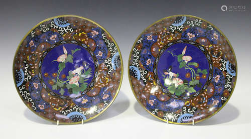 A pair of Japanese cloisonné circular dishes, Meiji period, each central blue ground floral panel