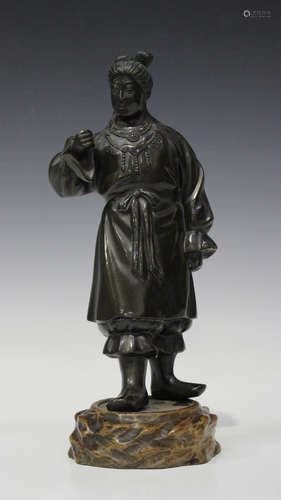 A Japanese brown patinated bronze figure of a woman, Meiji/Taisho period, modelled standing, wearing