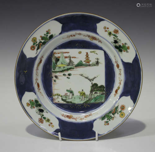 A Chinese famille verte blue ground export porcelain plate, Kangxi period, painted with a central
