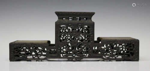 A Chinese hardwood three-tier stand, late Qing dynasty, of rectangular form, the raised central