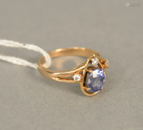 14 karat gold ring set with oval blue sapphire,