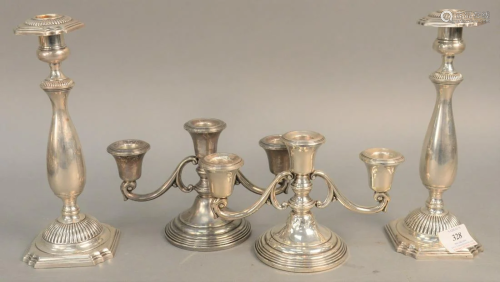 Four weighted sterling silver candlesticks. ht. 5 in.,