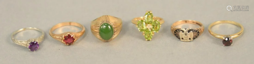 Six gold rings, five with stones, peridots, red sto…