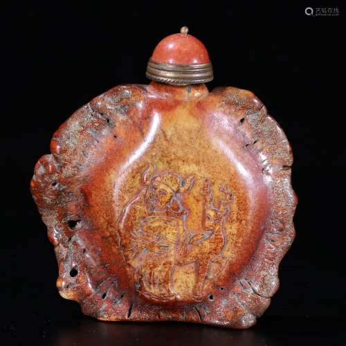 A Chinese carved snuff bottle.