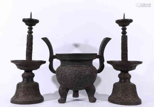 A Chinese Bronze Incense Burner and Pair of Candle Holders.