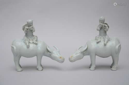 A pair of statues in blanc de Chine 'water buffalo with musician' (20x19cm)