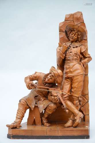 A large sculpture carved in wood 'violin player and pipe smoker', 19th century (40x63x105cm)