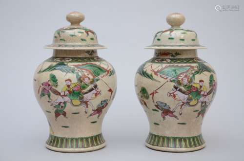 A pair of Nankin lidded vases 'warriors' (*) (37cm)