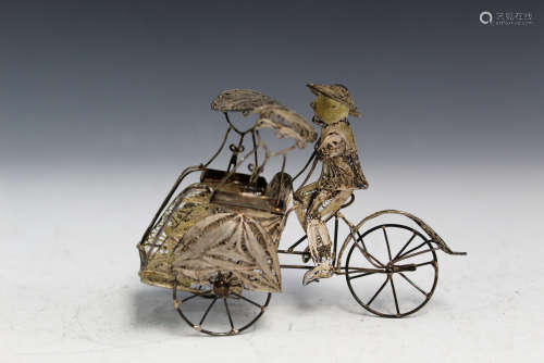 Chinese silver filigree model of a man riding a bicycle.