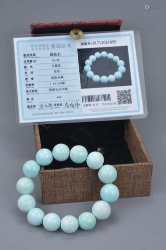 A Chinese turquoise beaded bracelet with 14 spherical beads. 62.69 grams total. 15mm diameter each b