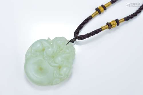 A Chinese carved jade Bi disc pendant surmounted with mythical beasts. 5cm length