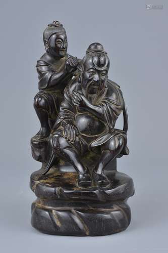 A Chinese 19th century hardwood carving of figure having his ear cleaned. 18.5cm tall