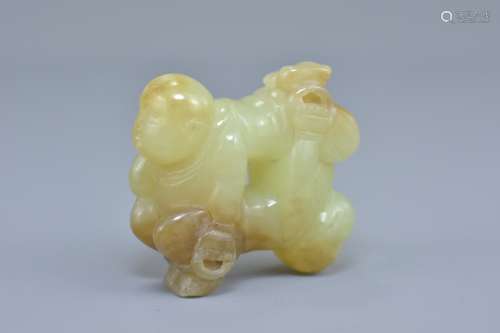 A Chinese celadon and brown jade carving of two boys. 5cm x 5cm