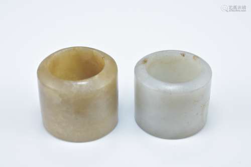 Two Chinese carved jade archers rings. 2.5cm and 3cm length (2)