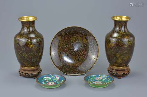 A pair of Chinese cloisonné vases on wooden stands with floral decoration together with a matching s