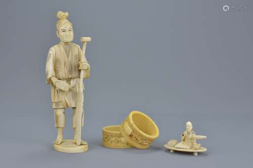 A Japanese Meiji period segmental ivory Okimono of a man with ore and turtle together with a pair of