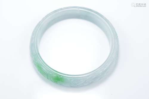 A Chinese carved jadeite bangle in pale white and green tone. Carved with Lingzhi. 5.75cm inner diam