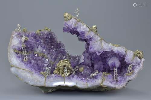 A large open natural amethyst rock crystal ornament with scene of pewter figures 'mining gold'. 36cm