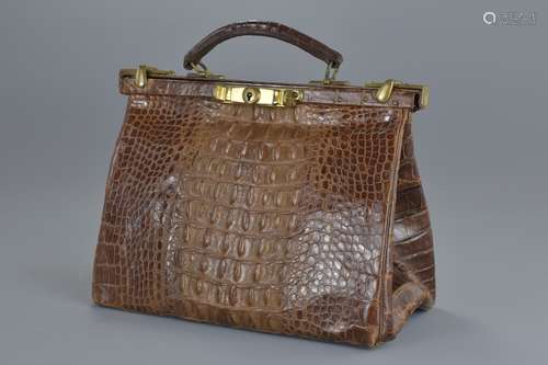 A vintage crocodile leather women's handbag with bronze fittings. No key unable to open. 26cm length