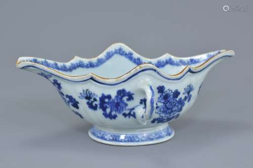 An 18th century Chinese blue and white porcelain sauce boat with twin looped handles decorated with