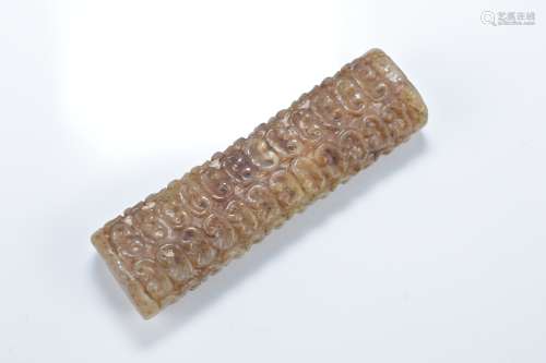 A Chinese Han style cylindrical jade pendant with carved pattern design. 7cm length