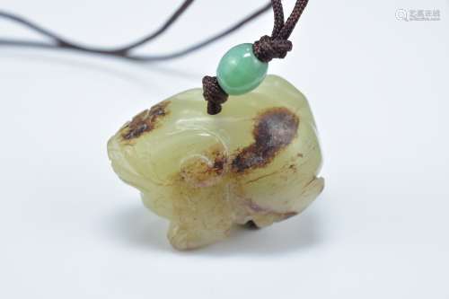 A Chinese carved celadon and brown jade animal pendant. 3.5cm length