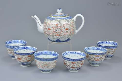 A set of six Chinese porcelain cups and teapot. (7)