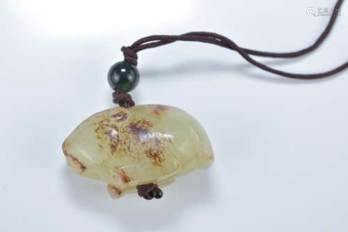 A Chinese carved celadon and brown jade animal pendant. 4.5cm length