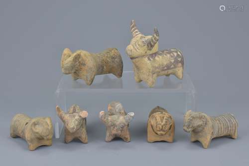 A group of seven miniature painted pottery animal figures. Sizes approx. 9cm to 10cm length (7)