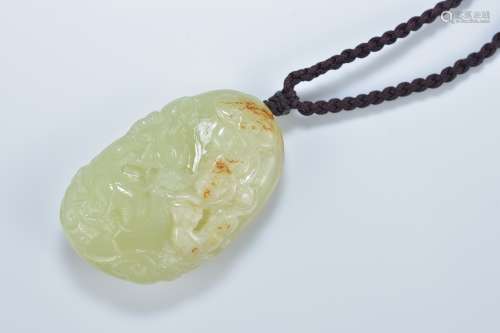 A Chinese celadon and brown jade pendant carved with fish. 5.5cm length