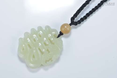 A Chinese celadon jade pendant carved with a 'Shou' character with a bat. 5cm length